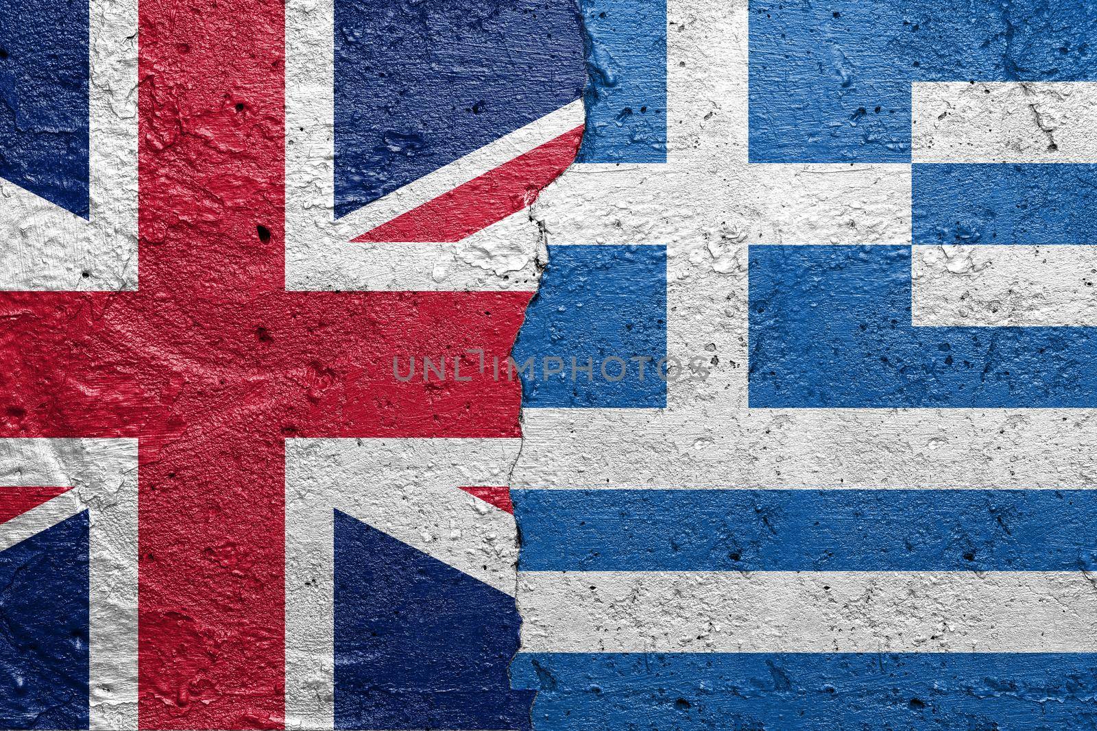 United Kingdom and Greece - Cracked concrete wall painted with a England flag on the left and a Greek flag on the right stock photo by adamr