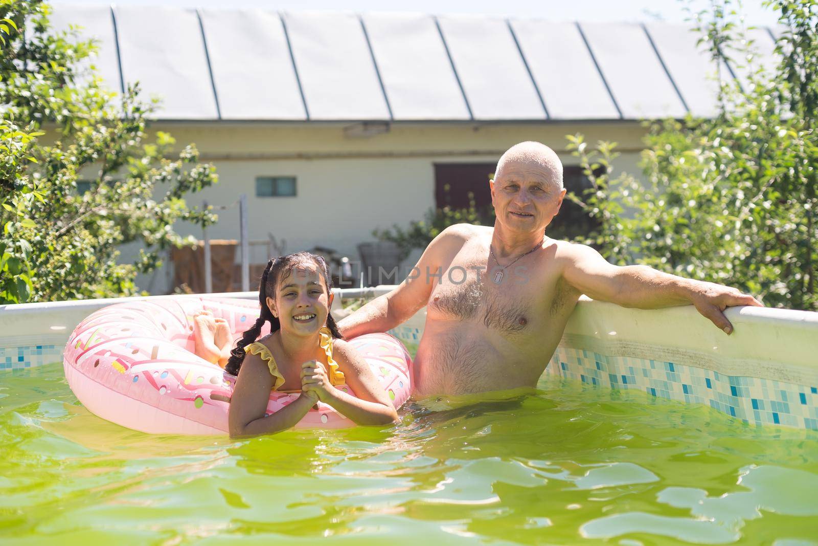 Grandfather and girl playing in water