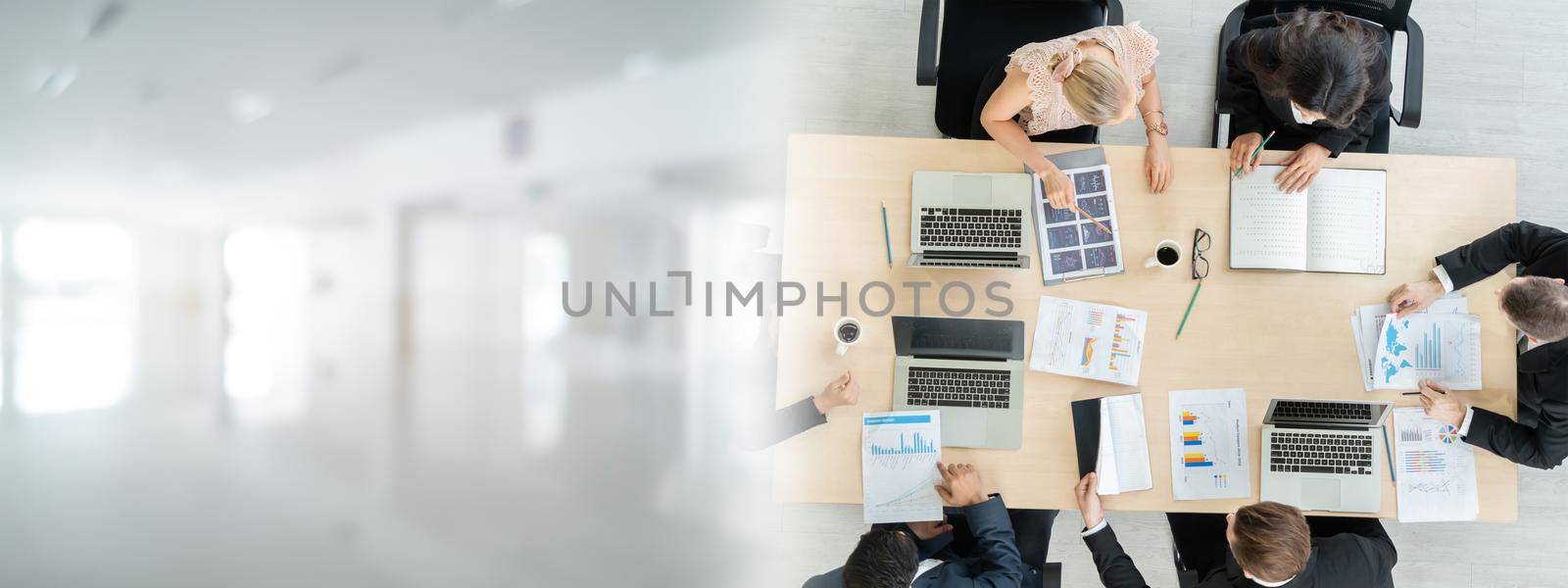 Business people group meeting shot from top widen view in office . Profession businesswomen, businessmen and office workers working in team conference with project planning document on meeting table .