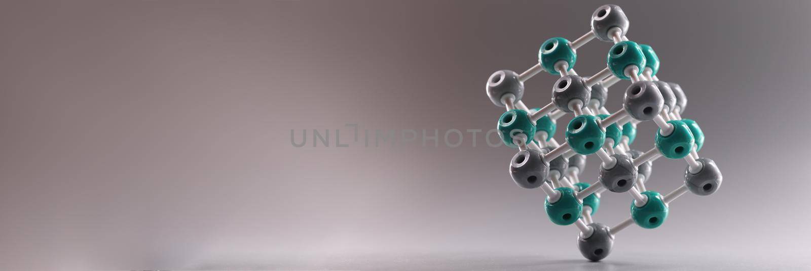 Plastic molecule in shape of square on gray background by kuprevich