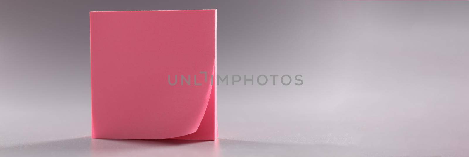 Closeup of pink stickers on gray background. Business organization concept
