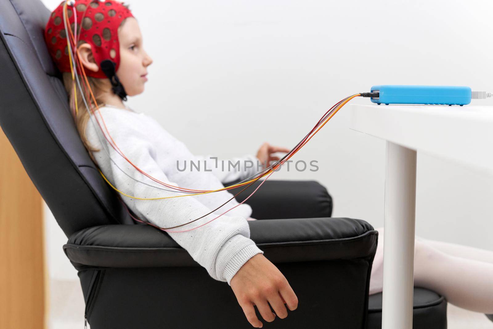 Profile of a girl sitting during a biofeedback session in a clinic by WesternExoticStockers