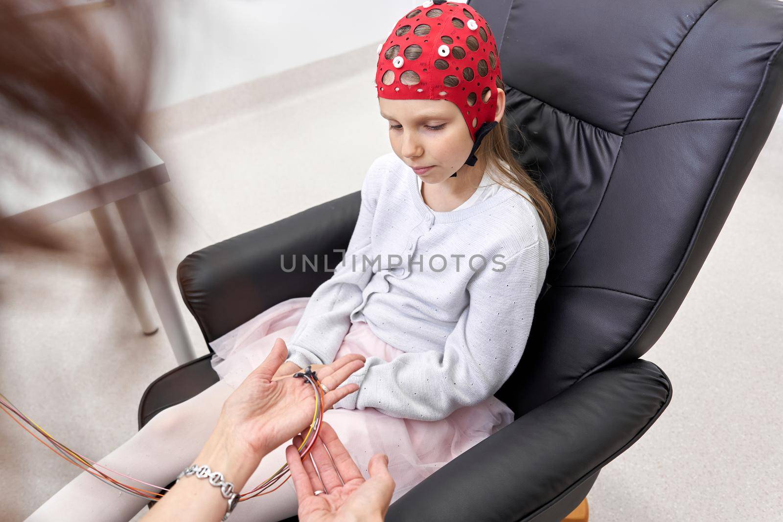 Doctor giving explanations to a girl during biofeedback therapy by WesternExoticStockers
