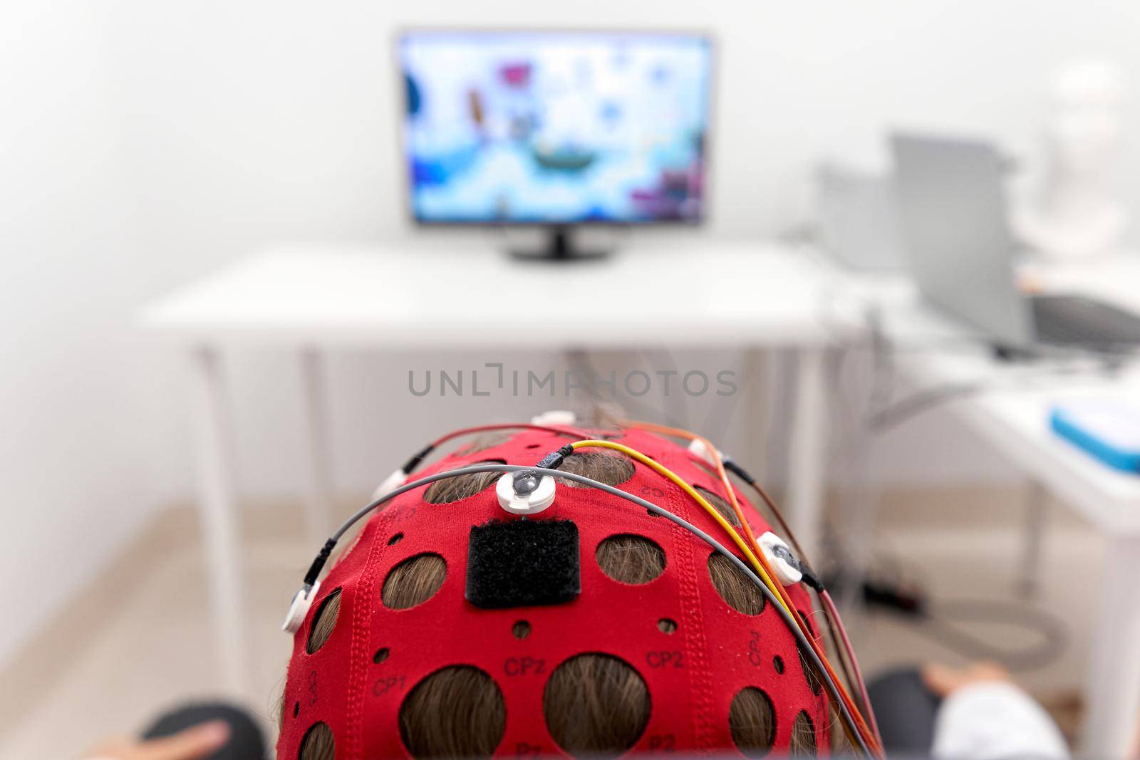 Focus on the headgear on a patient's while monitoring the impulses during a biofeedback session