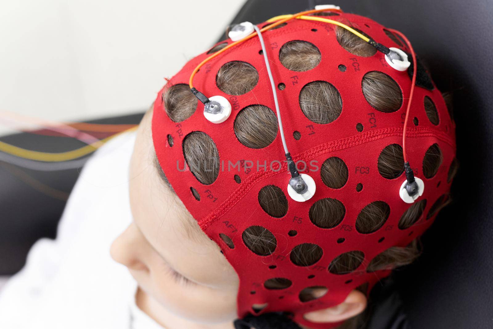 Top view of a girl wearing headgear during a session of biofeedback therapy