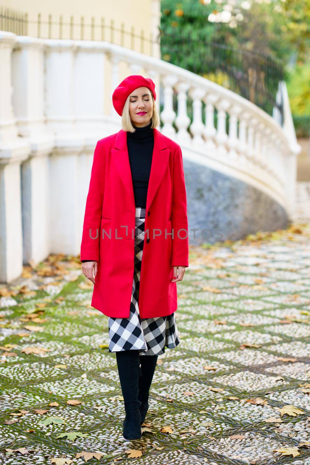 Stylish woman in red outfit on street by javiindy