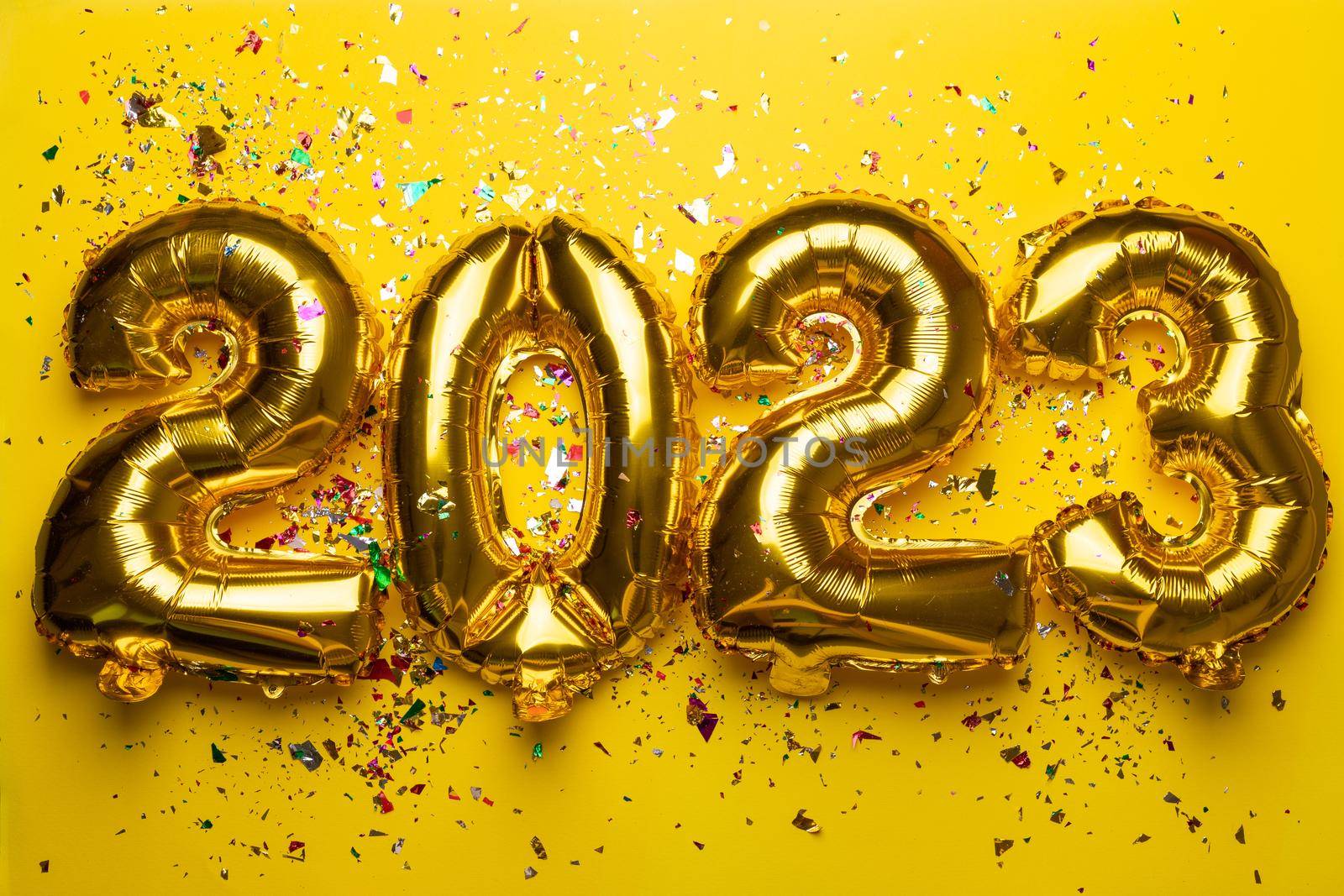 2023 Happy New Year concept from golden foil balloon by adamr