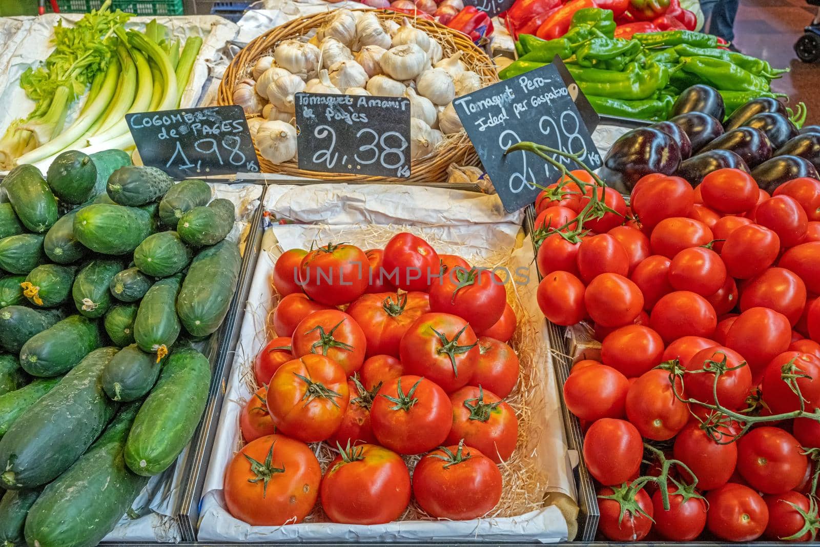Tomatoes, pickles and garlic for sale at a market