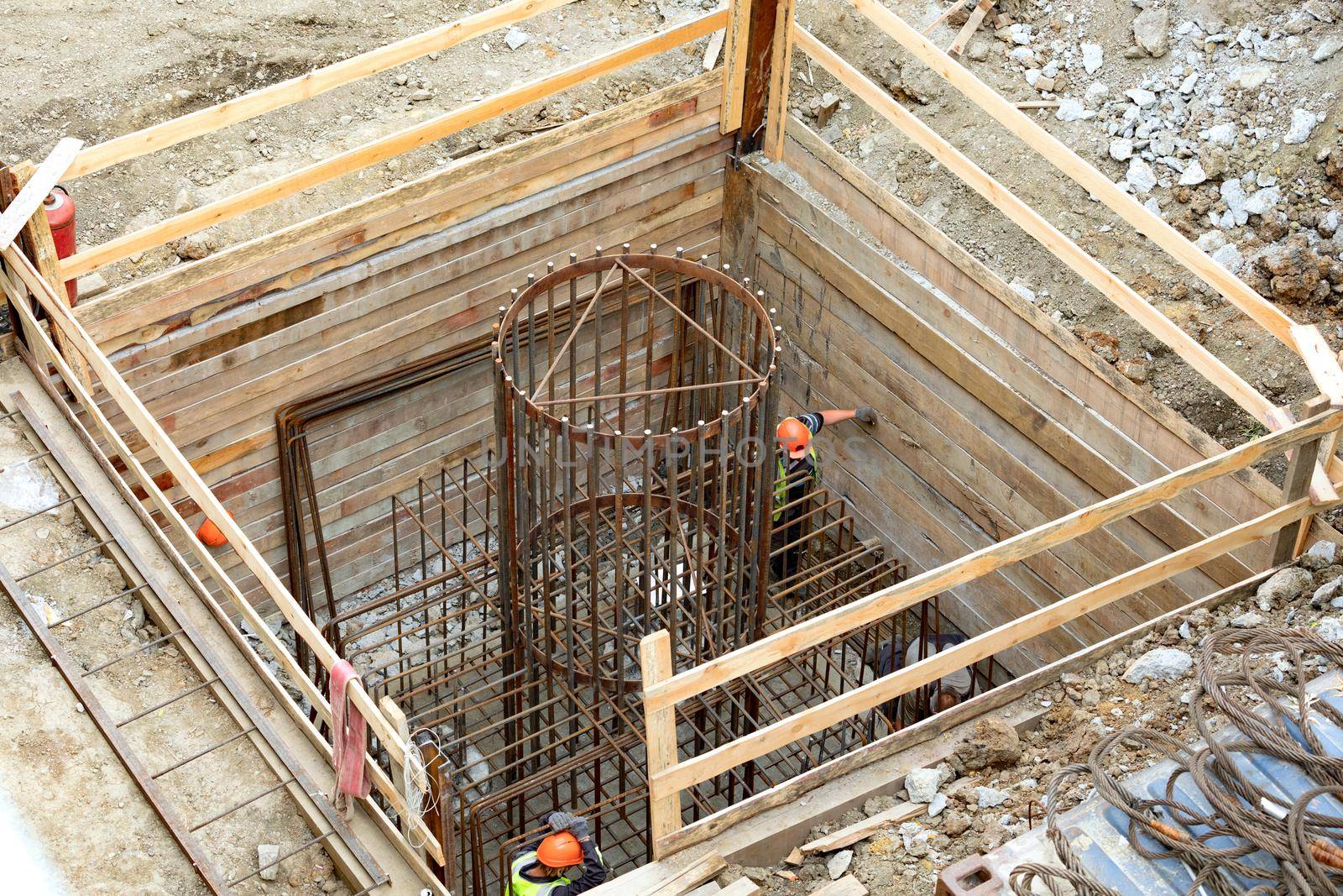 Construction site. Workers making a formwork for a concrete column