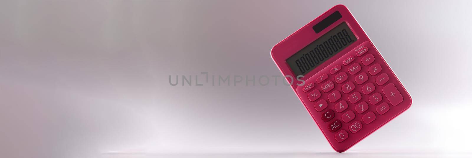 Closeup of pink calculator on gray background by kuprevich