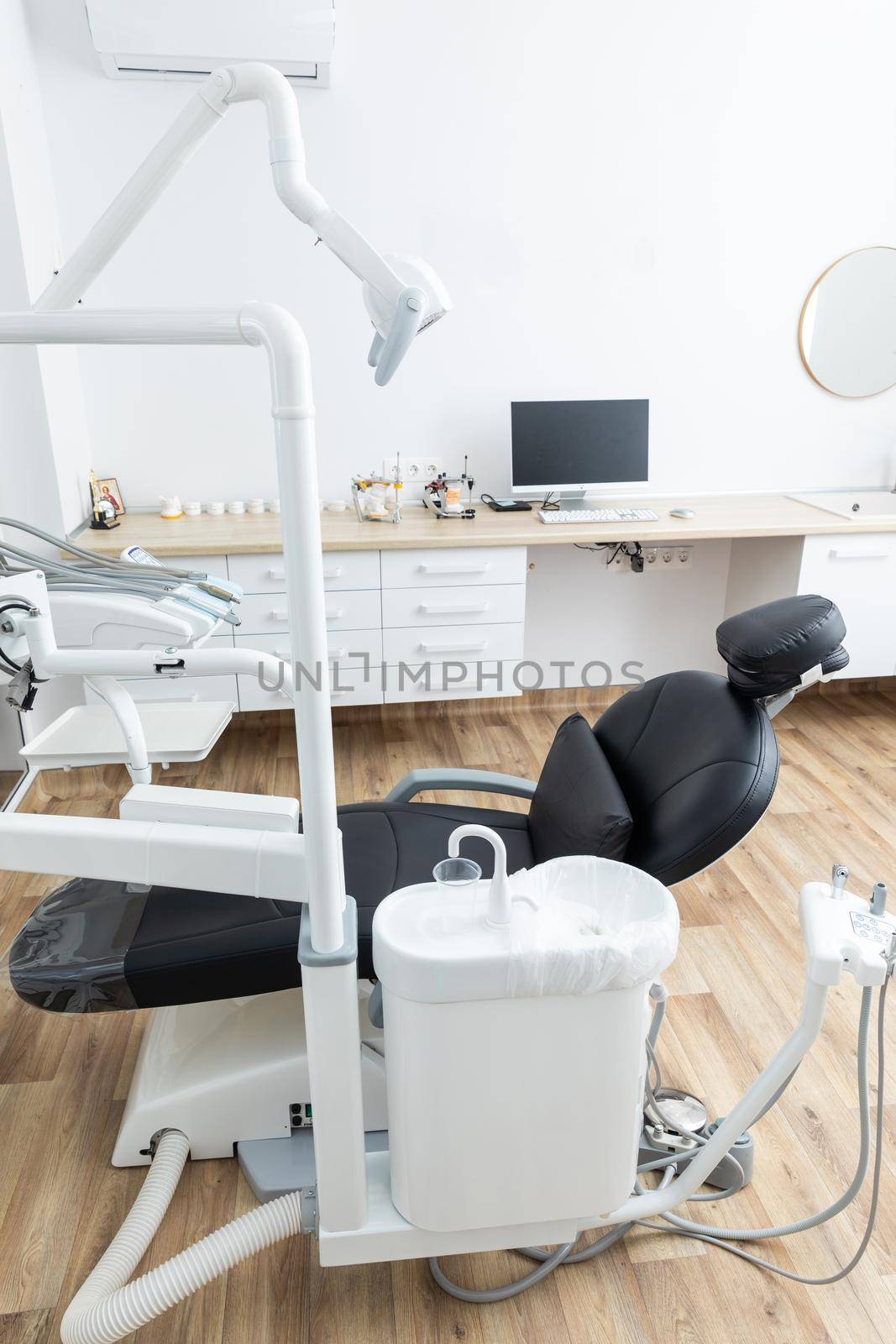 Modern dental cabinet in white colors. Defferent dental equipment, chair, lamp, drill machines. Concept dental treatment with microscope