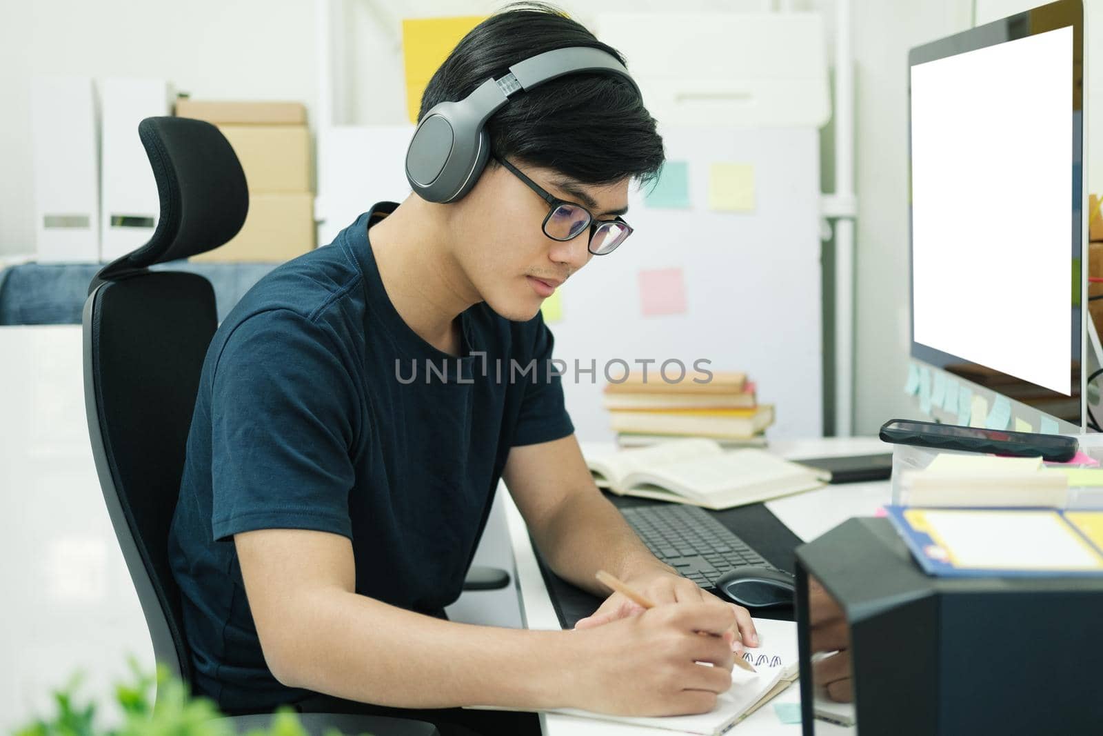 Young male student study at home. He using laptop and learning online.