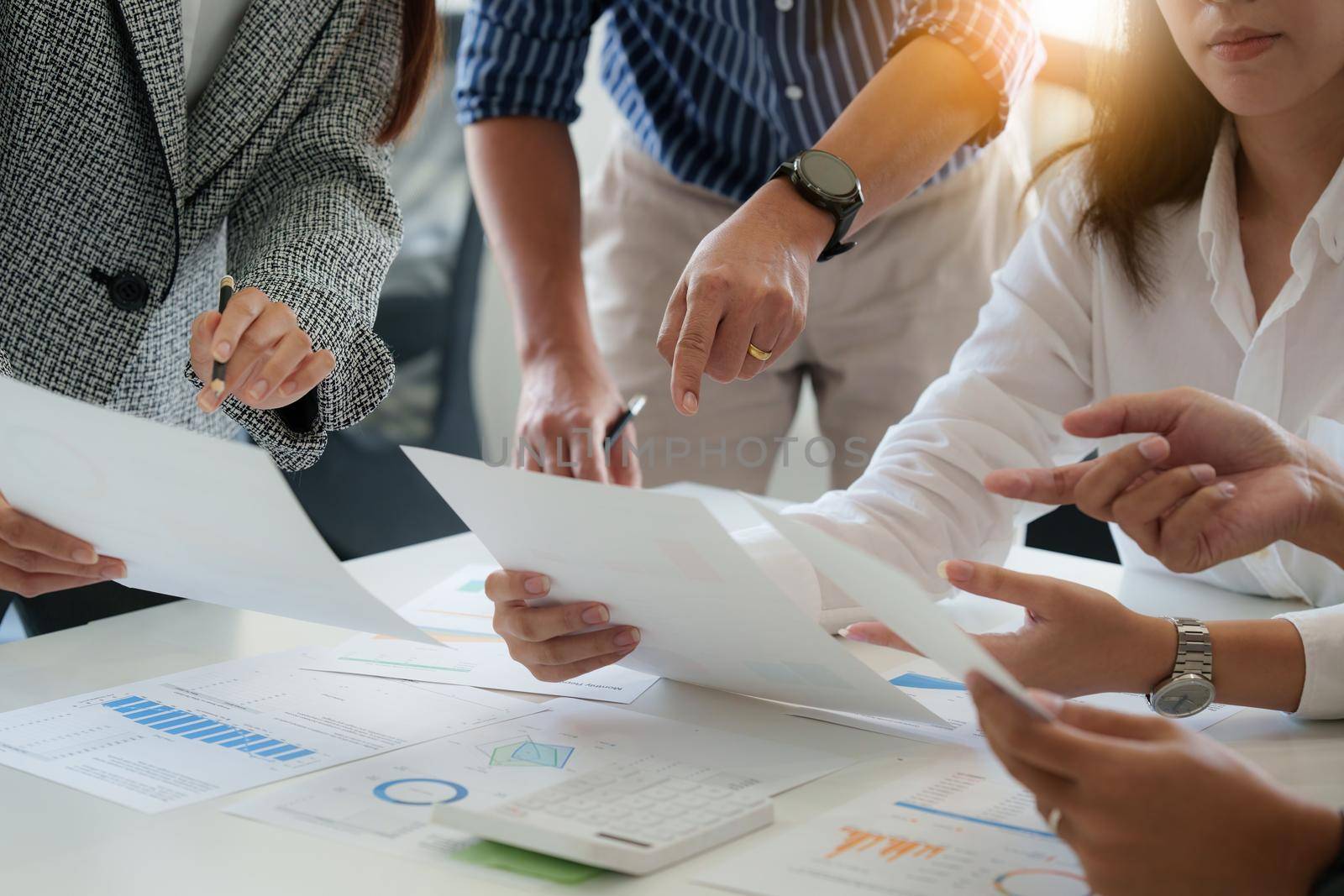 Group of business people working at workplace. Business team hands at working with financial plan, meeting, discussion, brainstorm with tablet on office desk