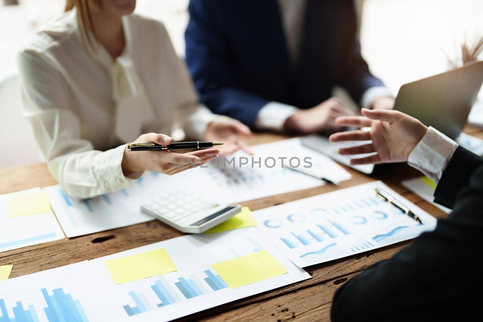 financial, Brainstorming, Consulting, Data Analysis, Planning, Marketing and Accounting, Economist pointing to investment documents with partners on profit taking to compete with other companies