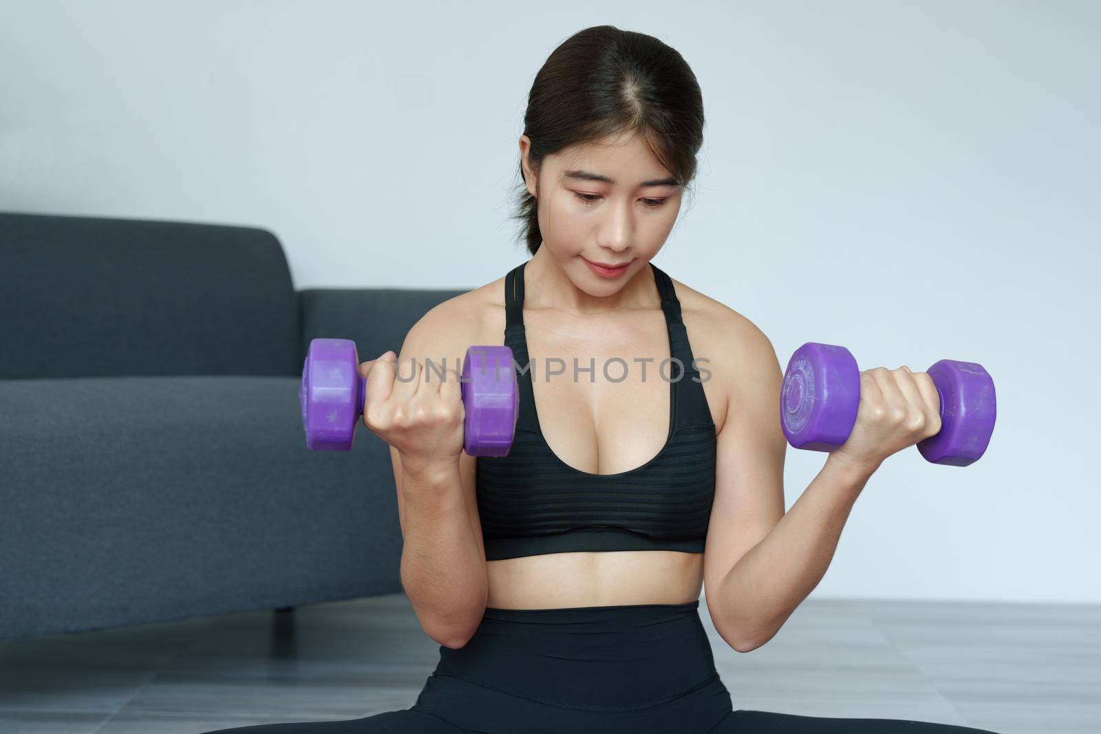 stress relief, , breathing exercises, meditation, portrait of Asian healthy woman lifting weights to strengthen her muscles after work