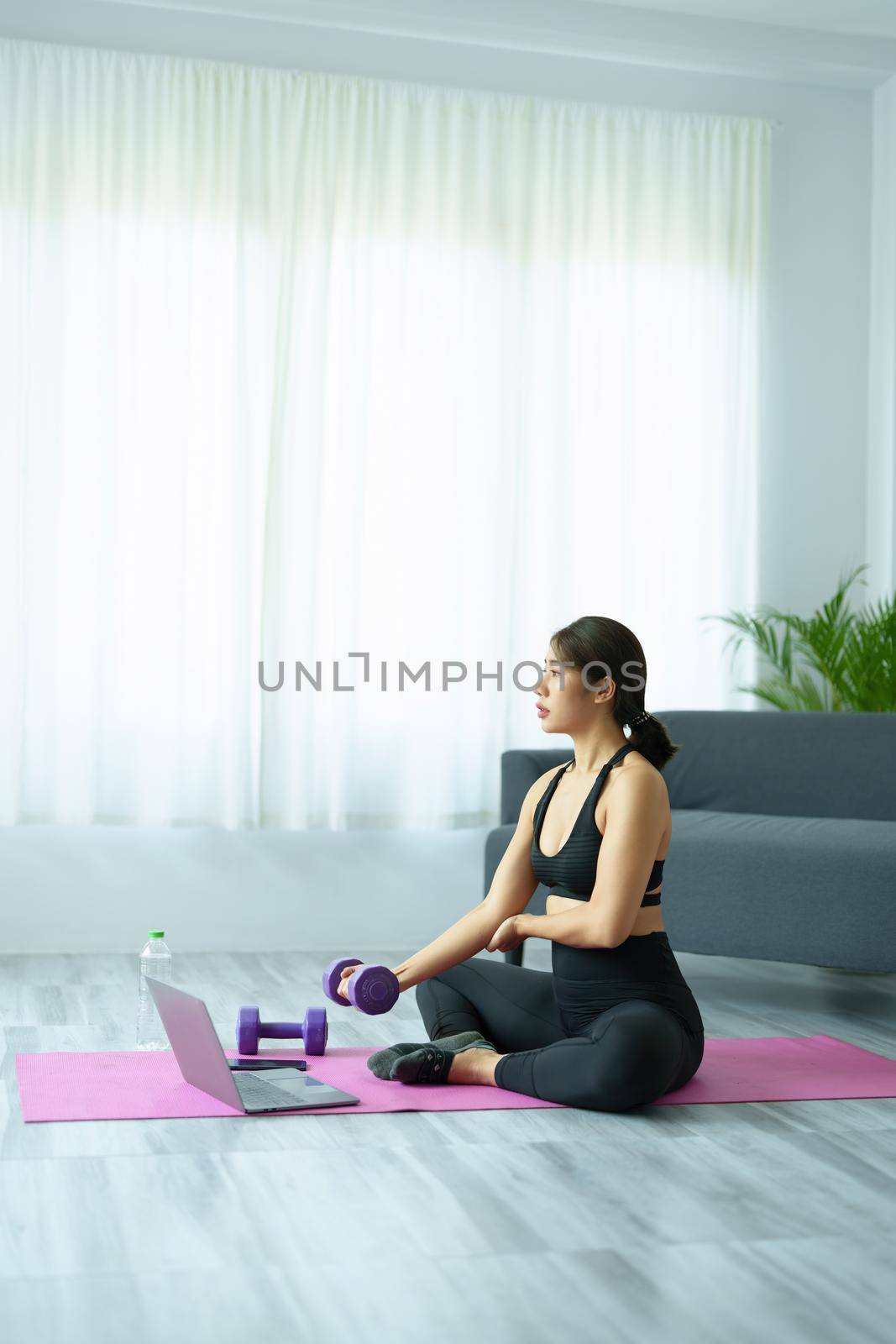 stress relief, , breathing exercises, meditation, portrait of Asian healthy woman lifting weights to strengthen her muscles after work