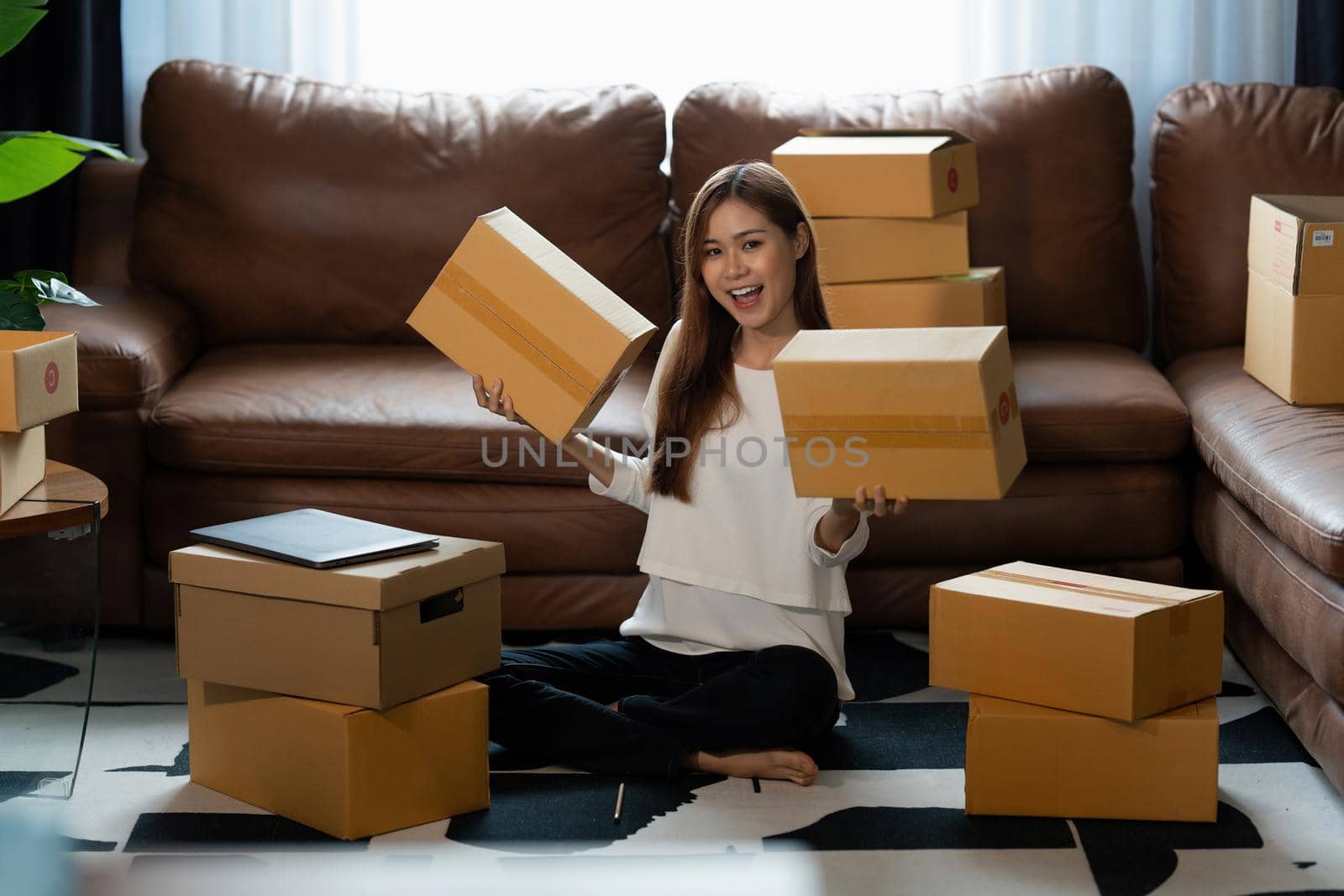 Image of Young asian woman startup freelance with parcel box. Online marketing packing box delivery concept