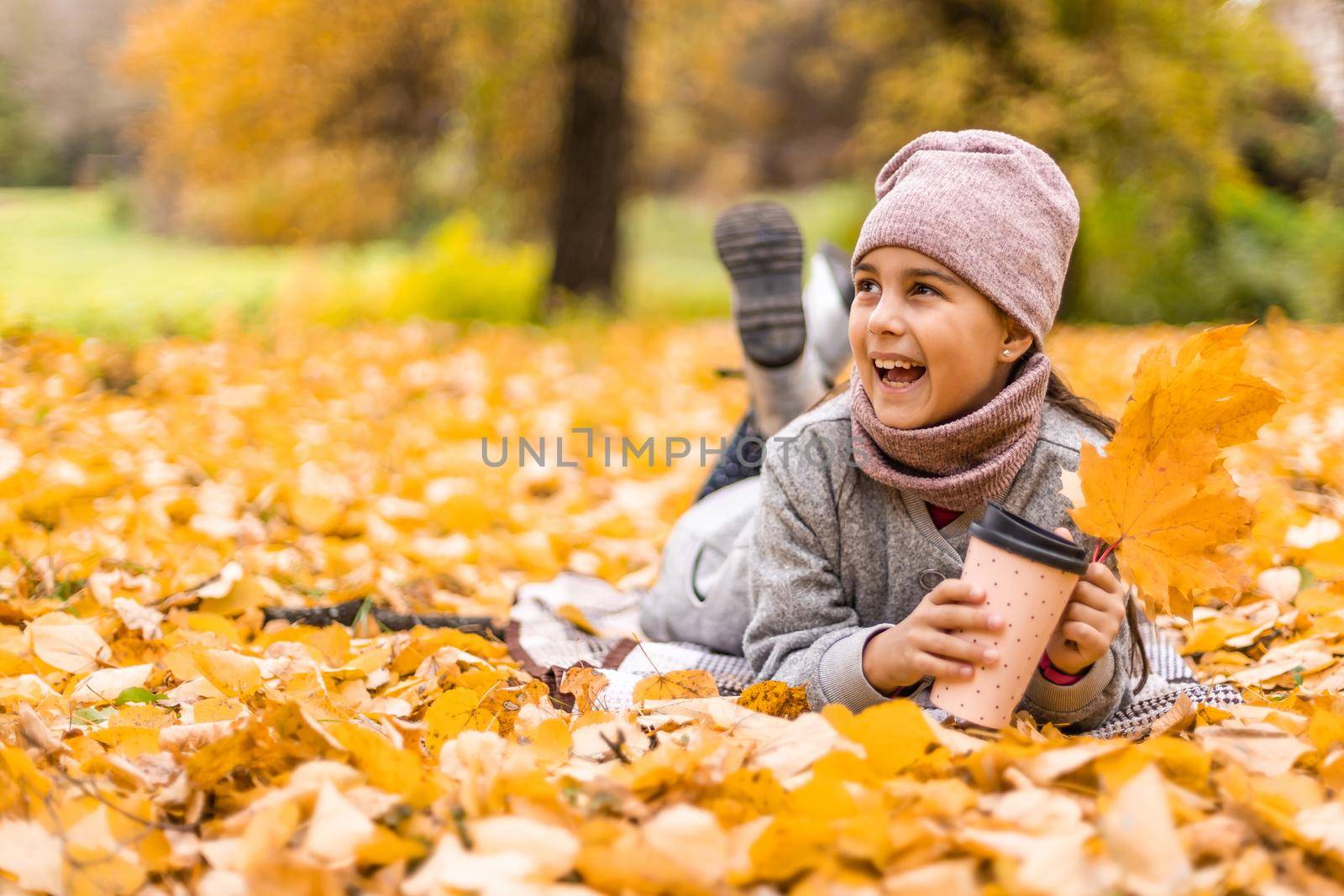 Kids play in autumn park. Children throwing yellow leaves. Child girl with maple leaf. Fall foliage. Family outdoor fun in autumn. Toddler or preschooler in fall.