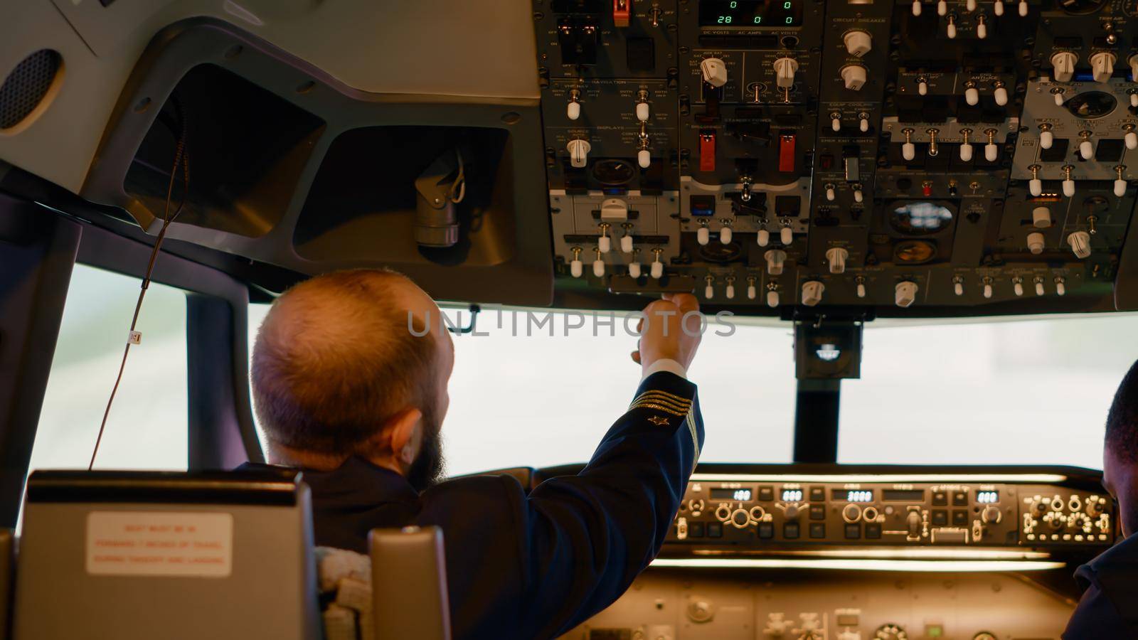 Flying aircrew preparing to takeoff with airplane in cockpit, using control panel command and dashboard buttons for navigation. Windscreen and power engine with handle and lever to fly.