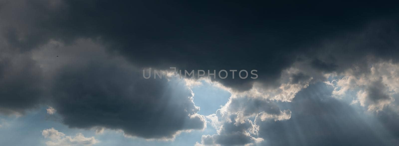 clouds in the sky. panorama sky and clouds with sun over. sun rays through the clouds