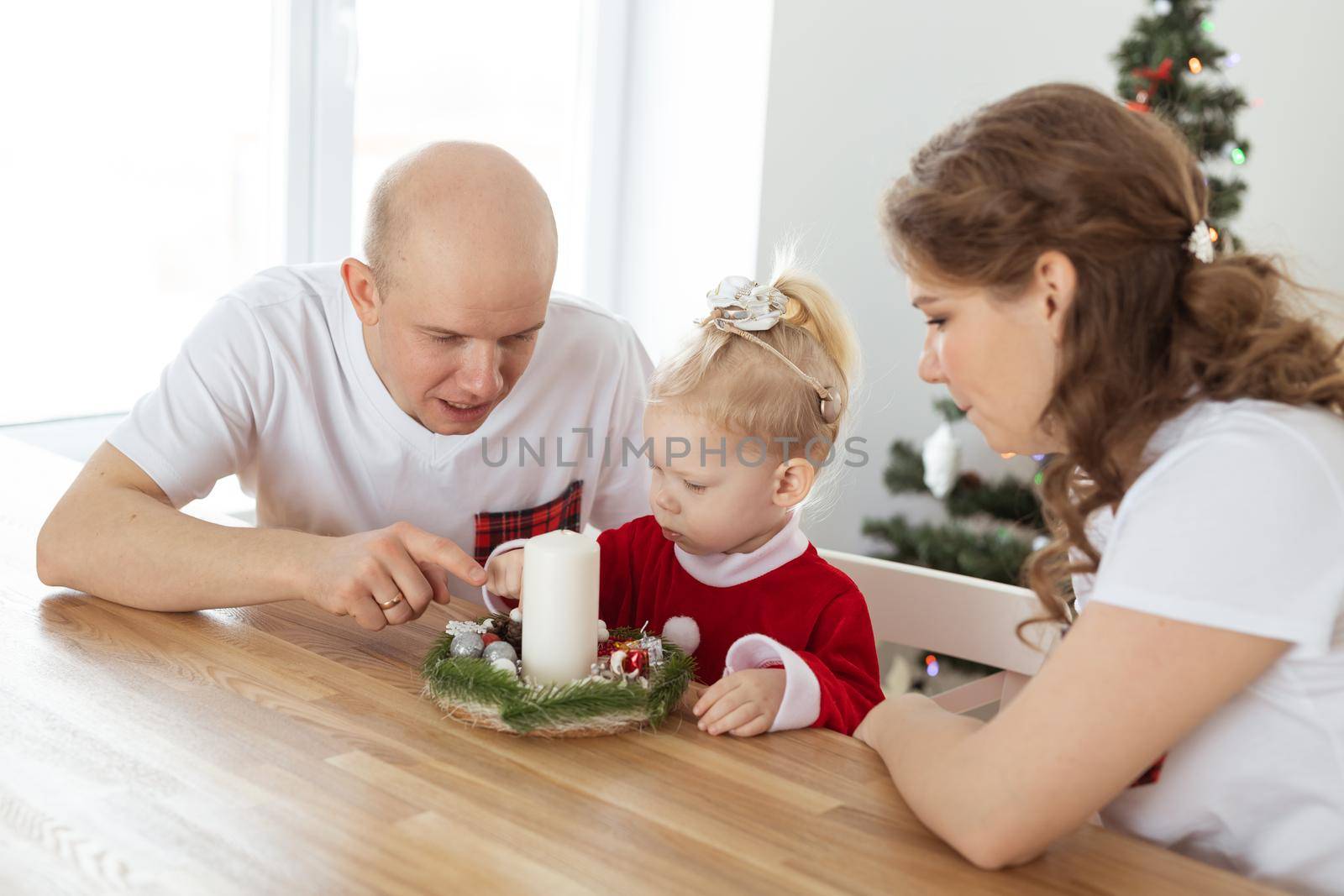 Child girl dressed in christmas dress with cochlear implants having fun at home - diversity and hearing aid and innovating technologies for treatment of deafness. by Satura86