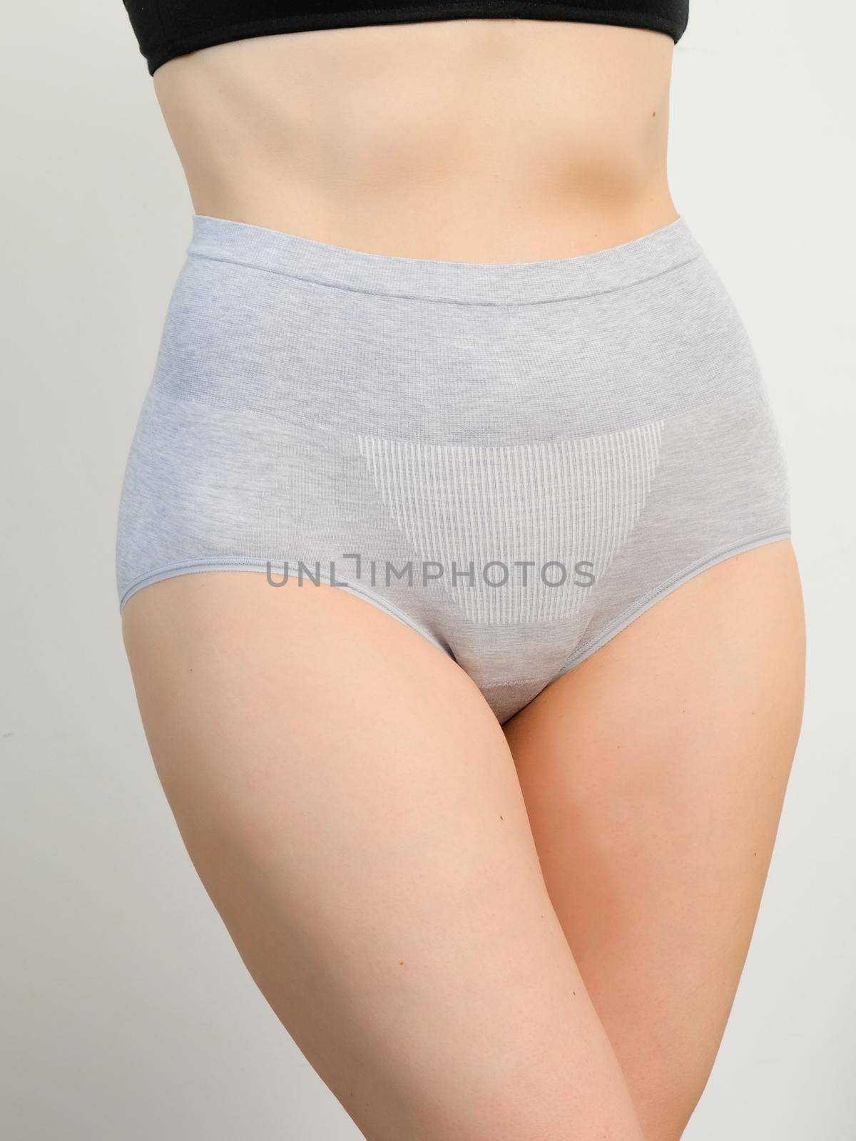 Close up portrait of a naked woman body in gray panties plus size, comfortable underwear lingerie