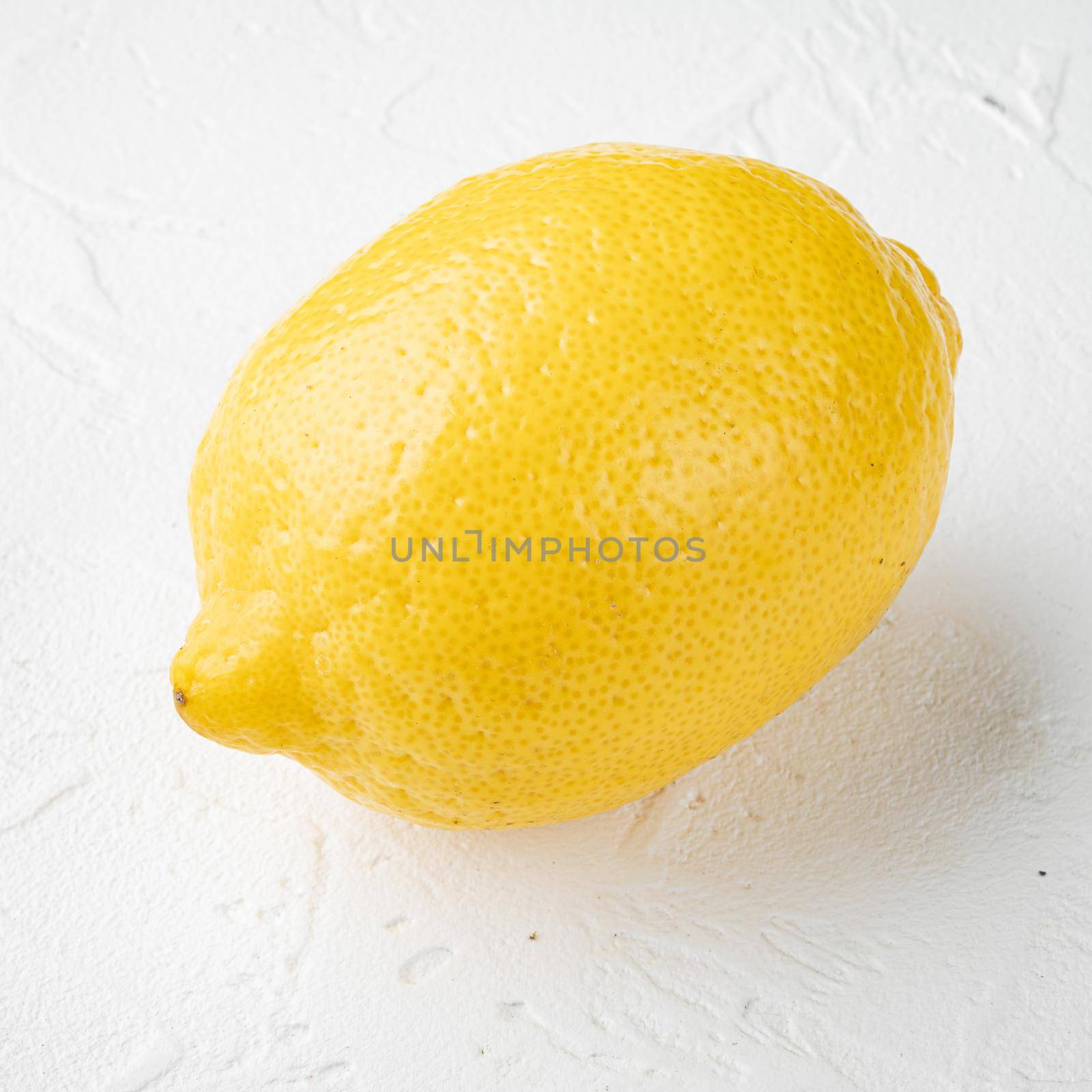 Whole lemons set, on white stone table background