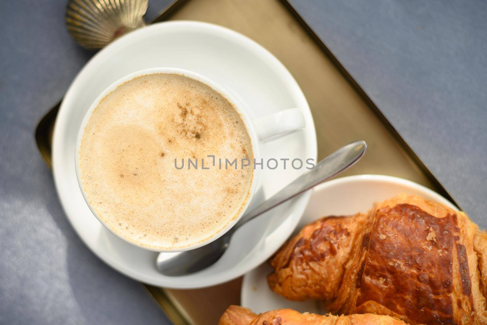 Coffee cup and fresh baked croissant by Ilianesolenyi