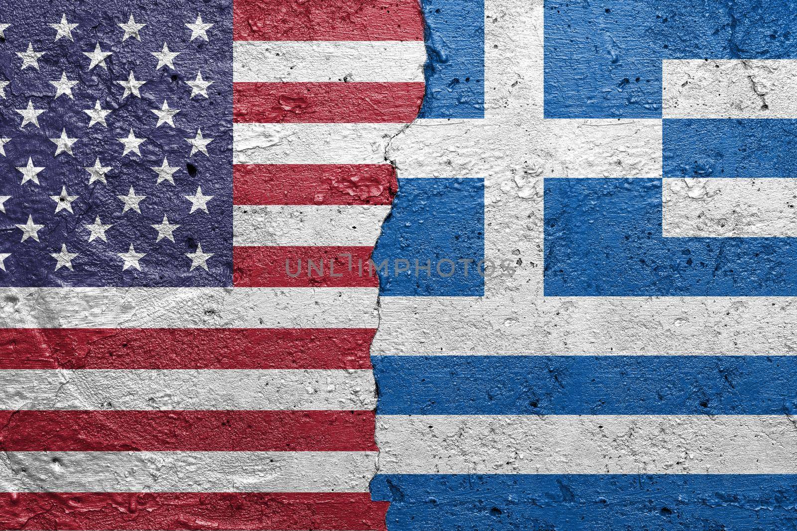 United States of America and Greece - Cracked concrete wall painted with a USA flag on the left and a Greek flag on the right