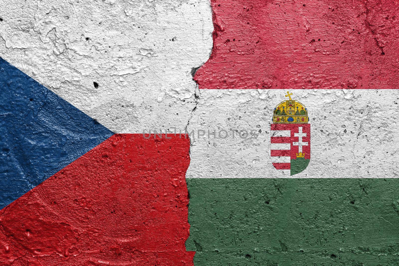 Czech Republic and Hungary - Cracked concrete wall painted with a Czech flag on the left and a Hungary flag on the right