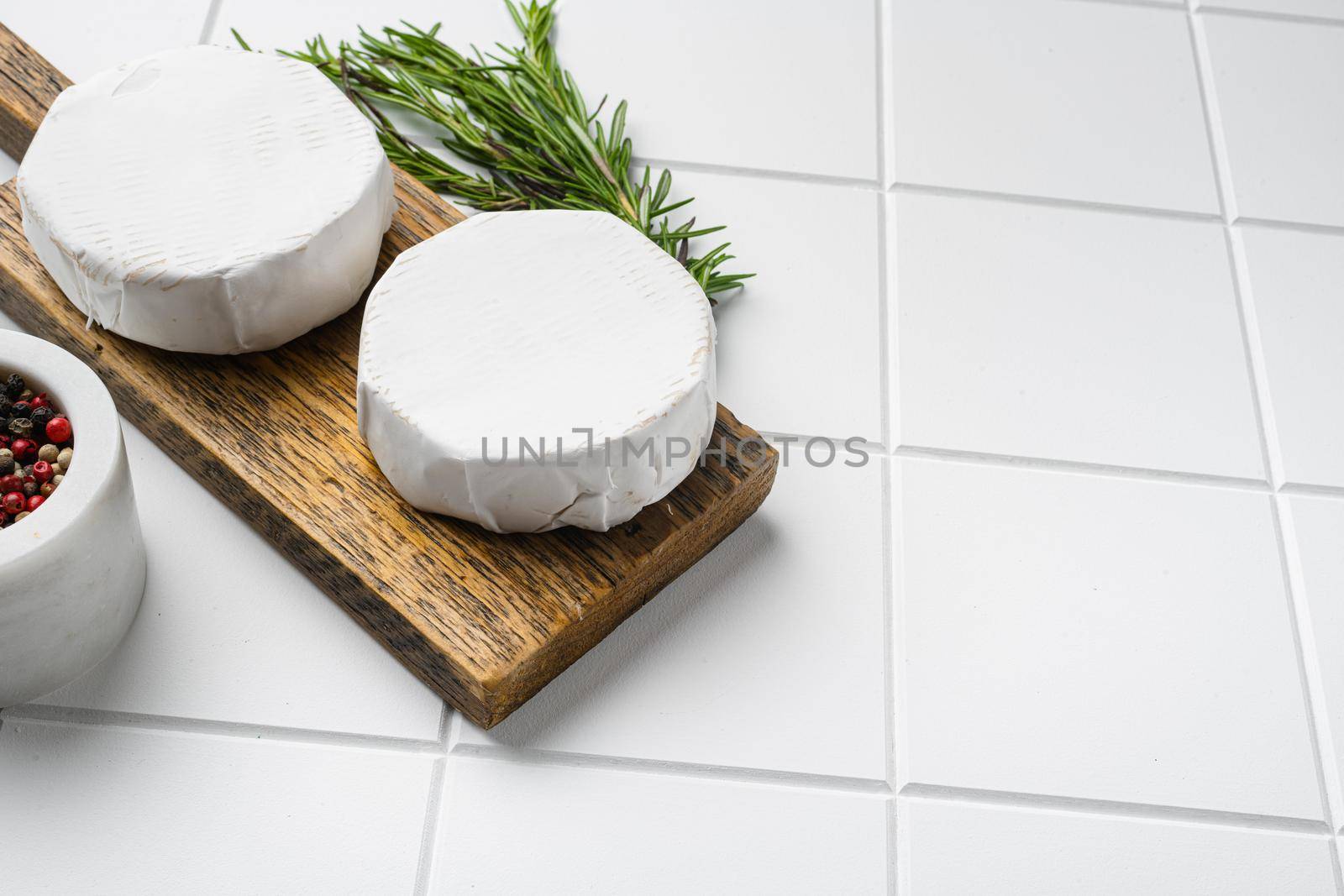 Creamy Brie cheese on white ceramic squared tile table background, with copy space for text by Ilianesolenyi