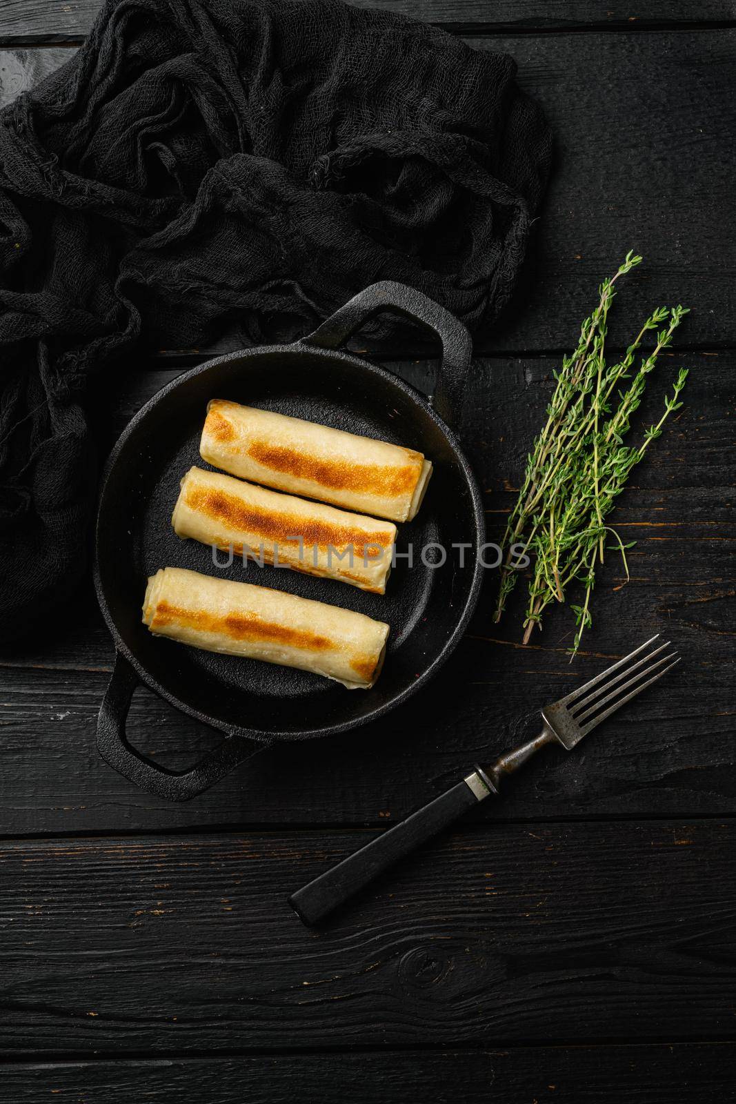 Georgian crepes stuffed on black wooden table background, top view flat lay, with copy space for text by Ilianesolenyi