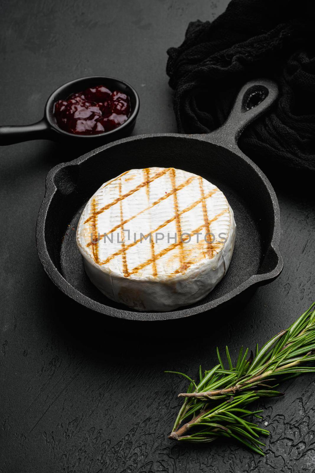 Oven Backed camembert on black dark stone table background by Ilianesolenyi