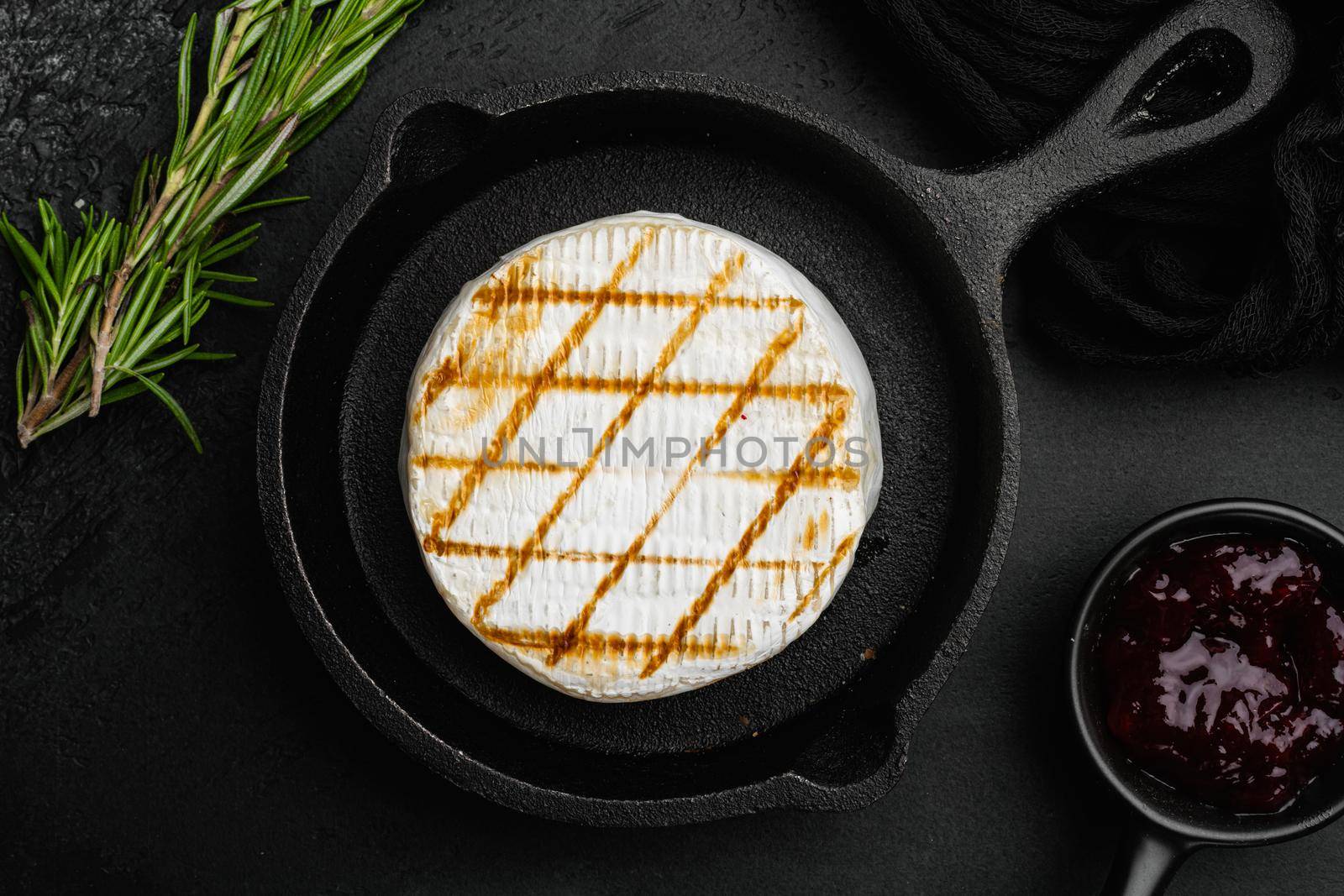 Oven Backed camembert on black dark stone table background, top view flat lay by Ilianesolenyi