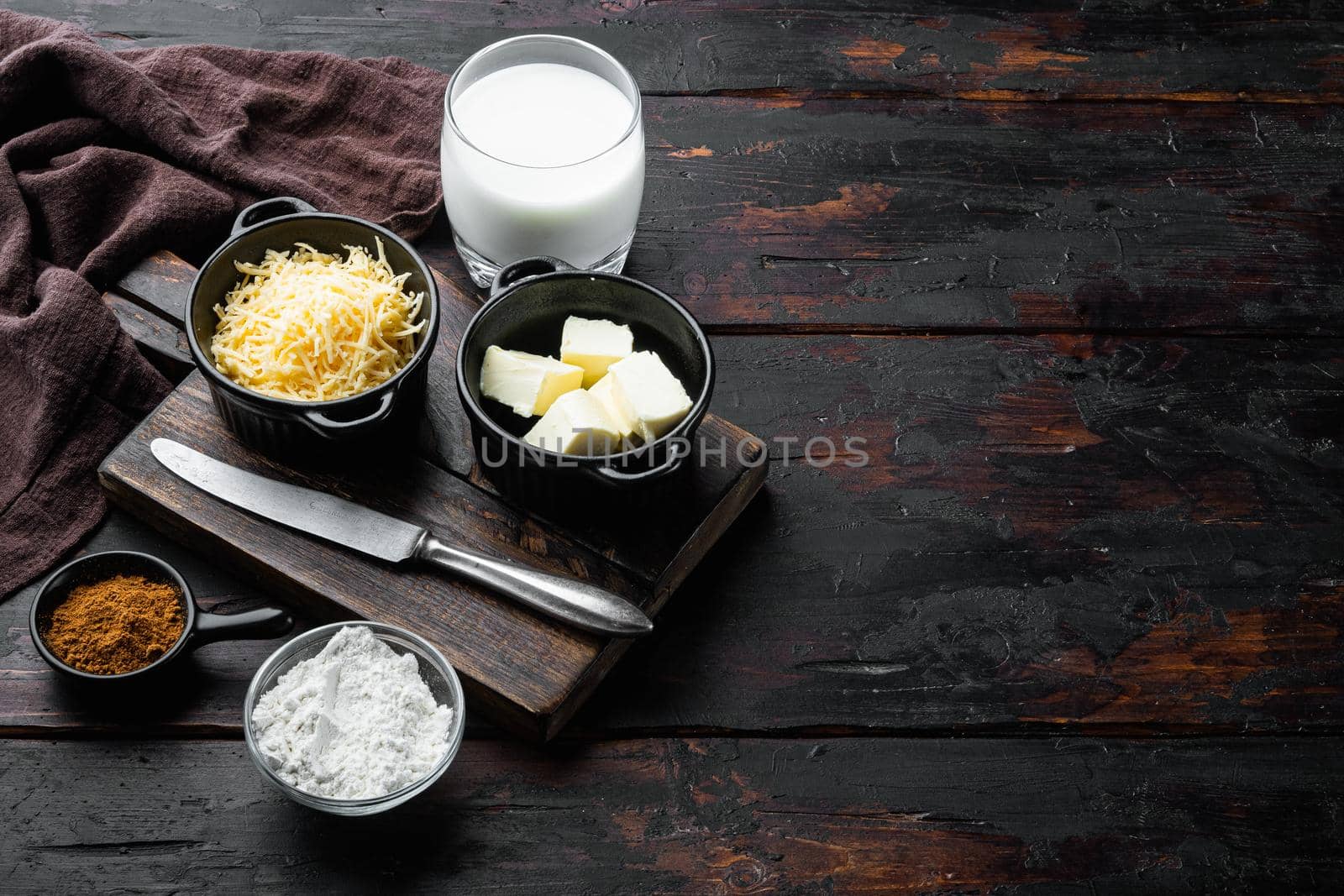White Bechamel sauce ingredients set, on old dark wooden table background, with copy space for text