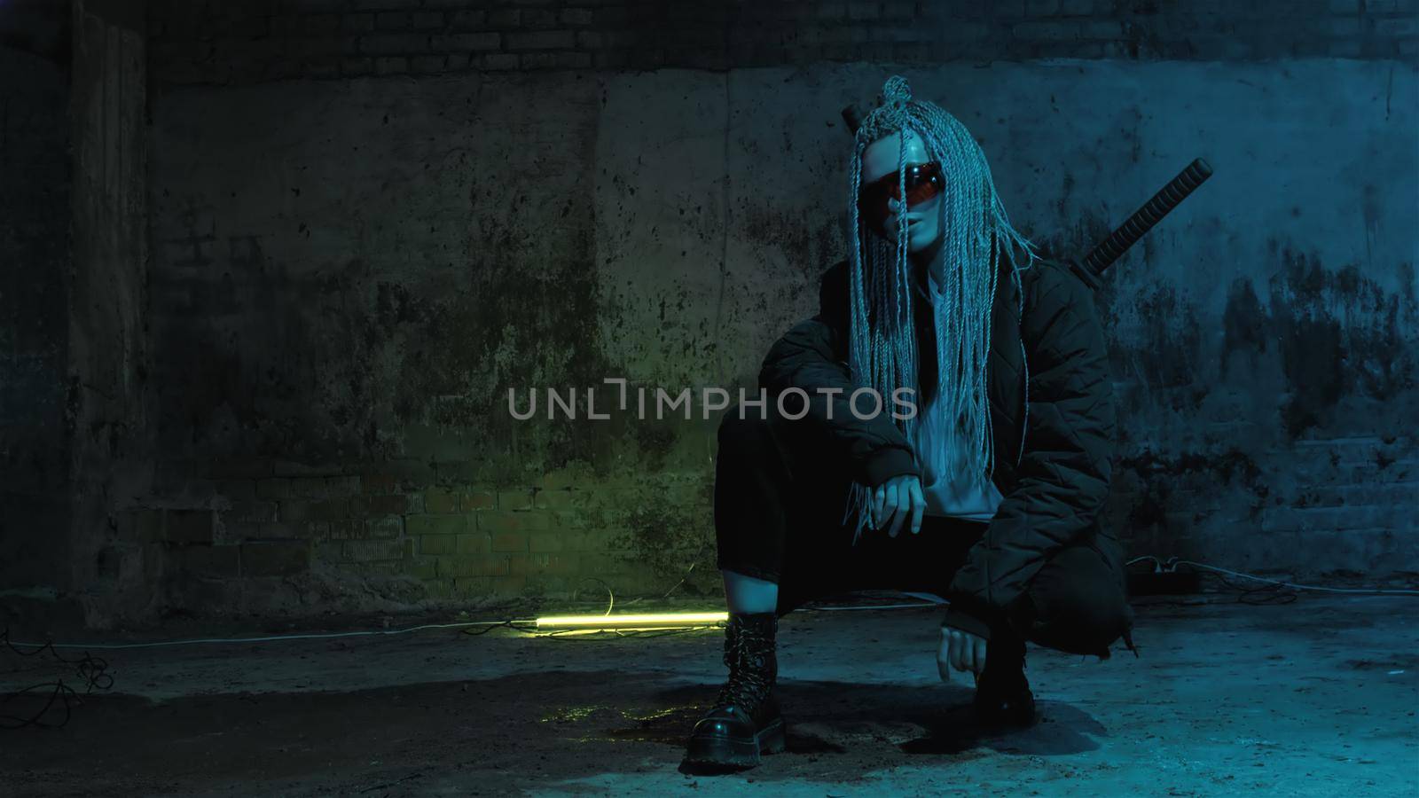 girl with dreadlocks and katanas in red glasses posing against a neon brick wall 4k