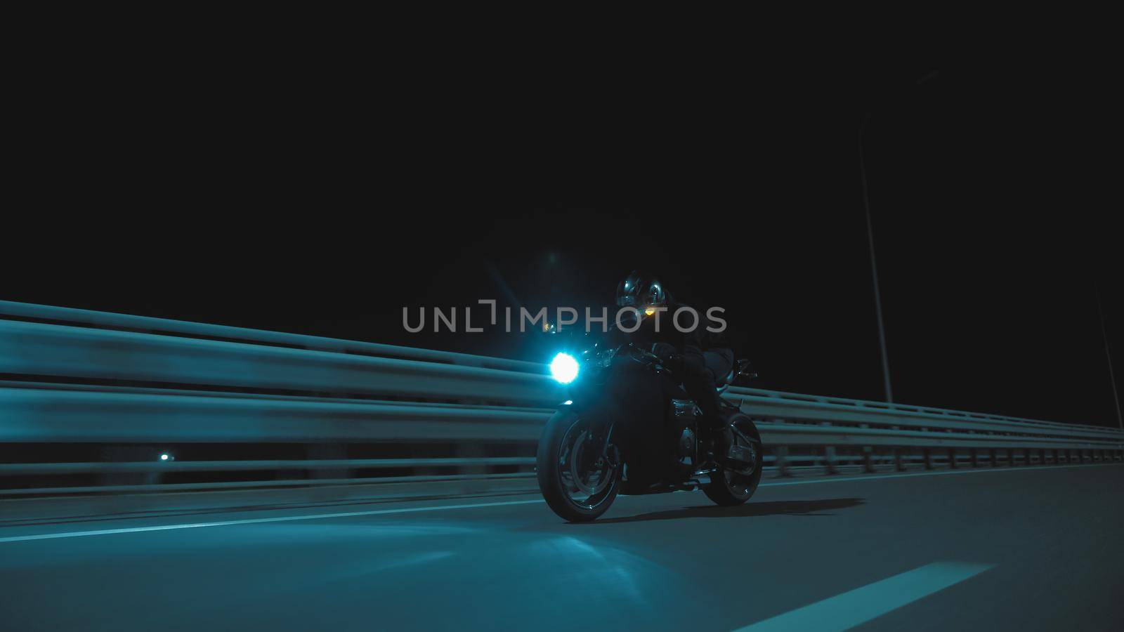 A man rides a sports motorcycle on a night track in 4k