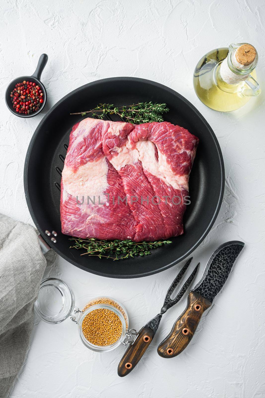 Packer brisket, raw beef brisket meat,with ingredients for smoking making barbecue, pastrami, cure, on white stone background, top view flat lay by Ilianesolenyi