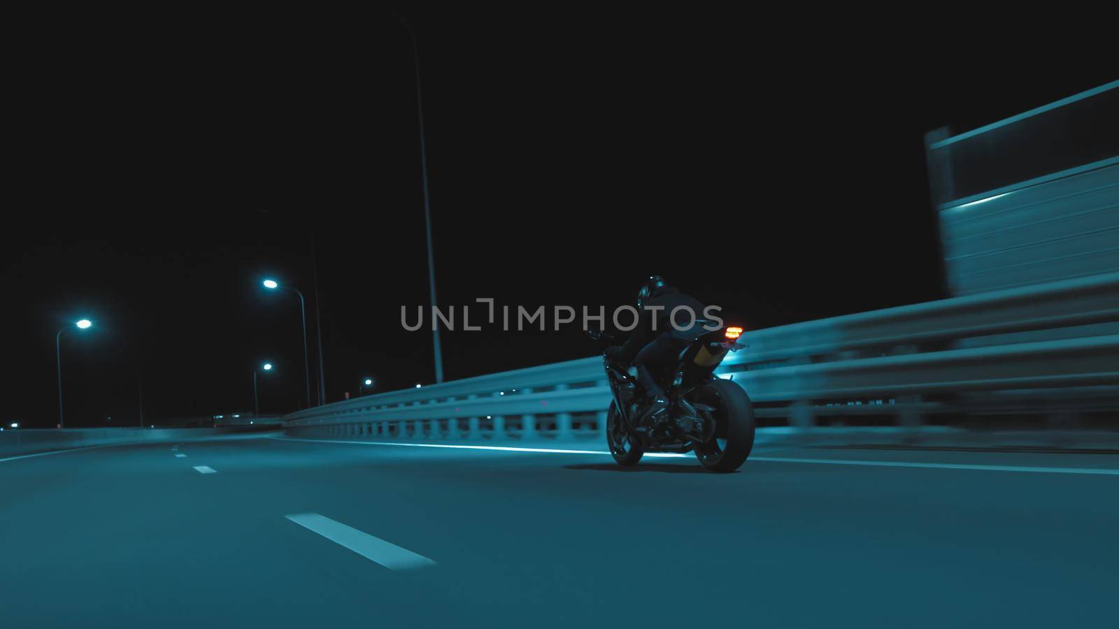 A man rides a sports motorcycle on a night track in 4k