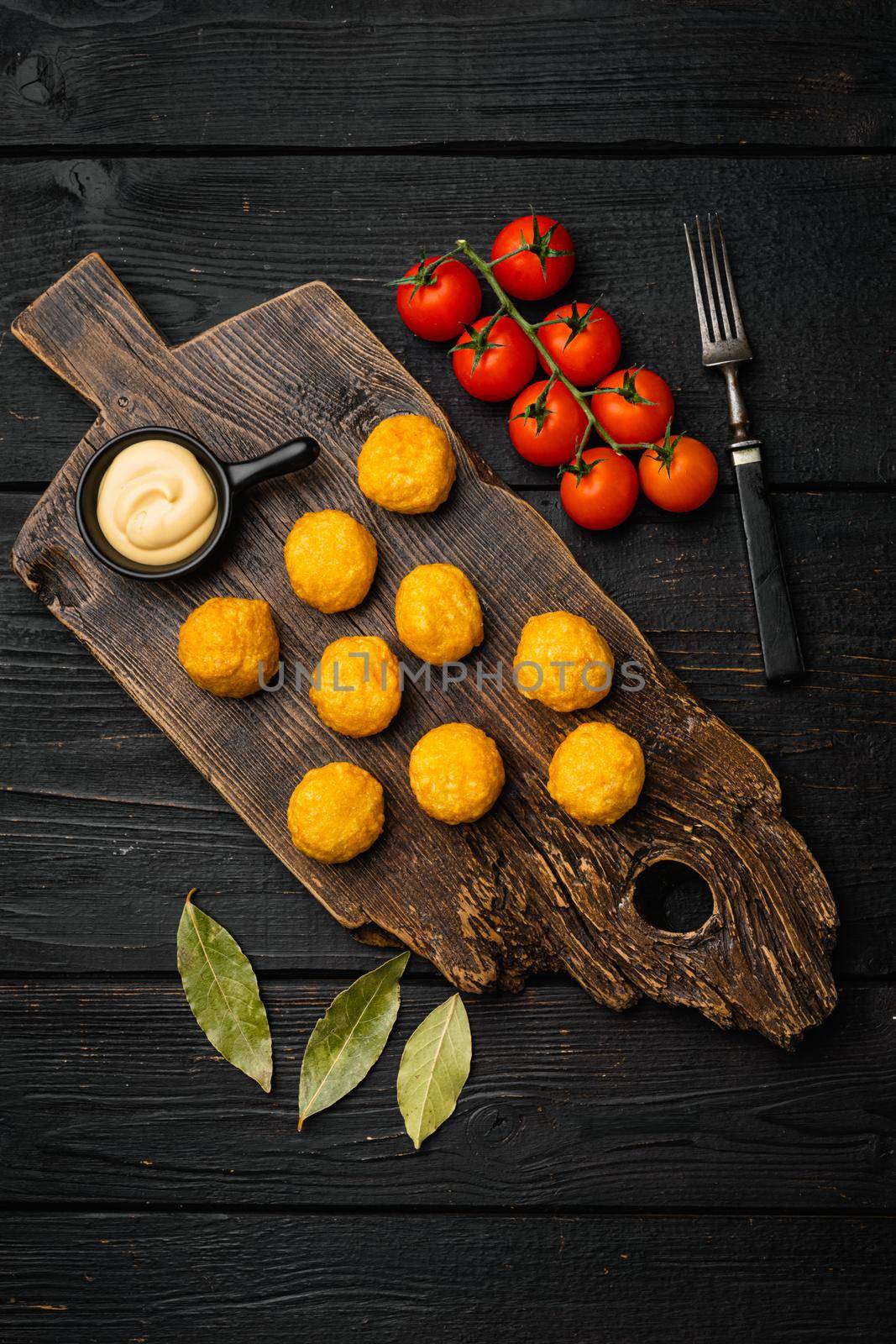 Battered meat, on black wooden table background, top view flat lay