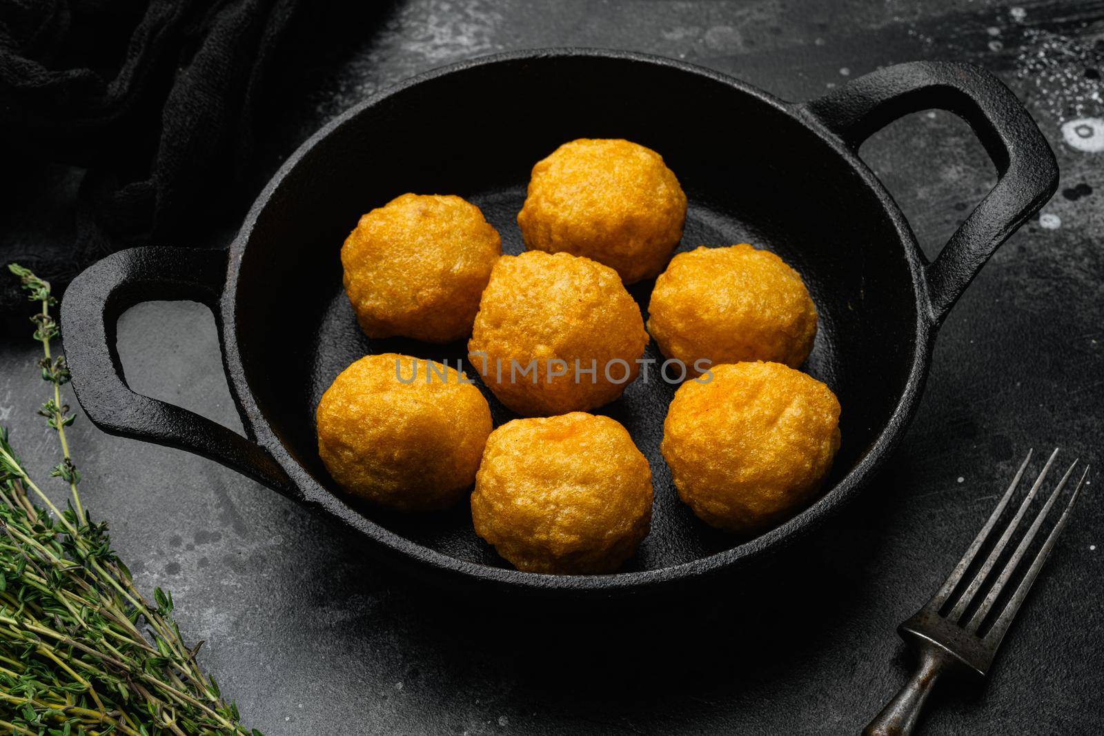 Breaded chicken fillet and batter, on black dark stone table background