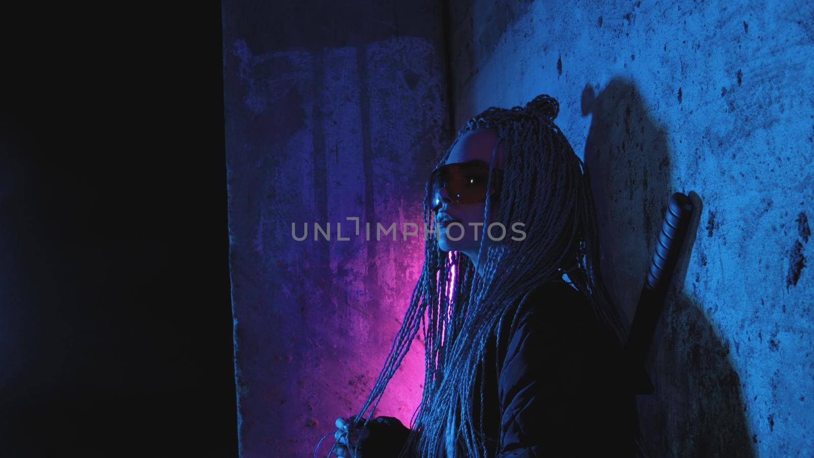 a girl with dreadlocks and katanas stands by a neon brick wall chewing gum by studiodav