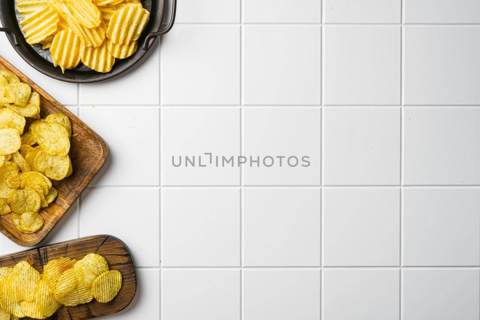 Honey BBQ Flavored Potato Chips, on white ceramic squared tile table background, top view flat lay, with copy space for text