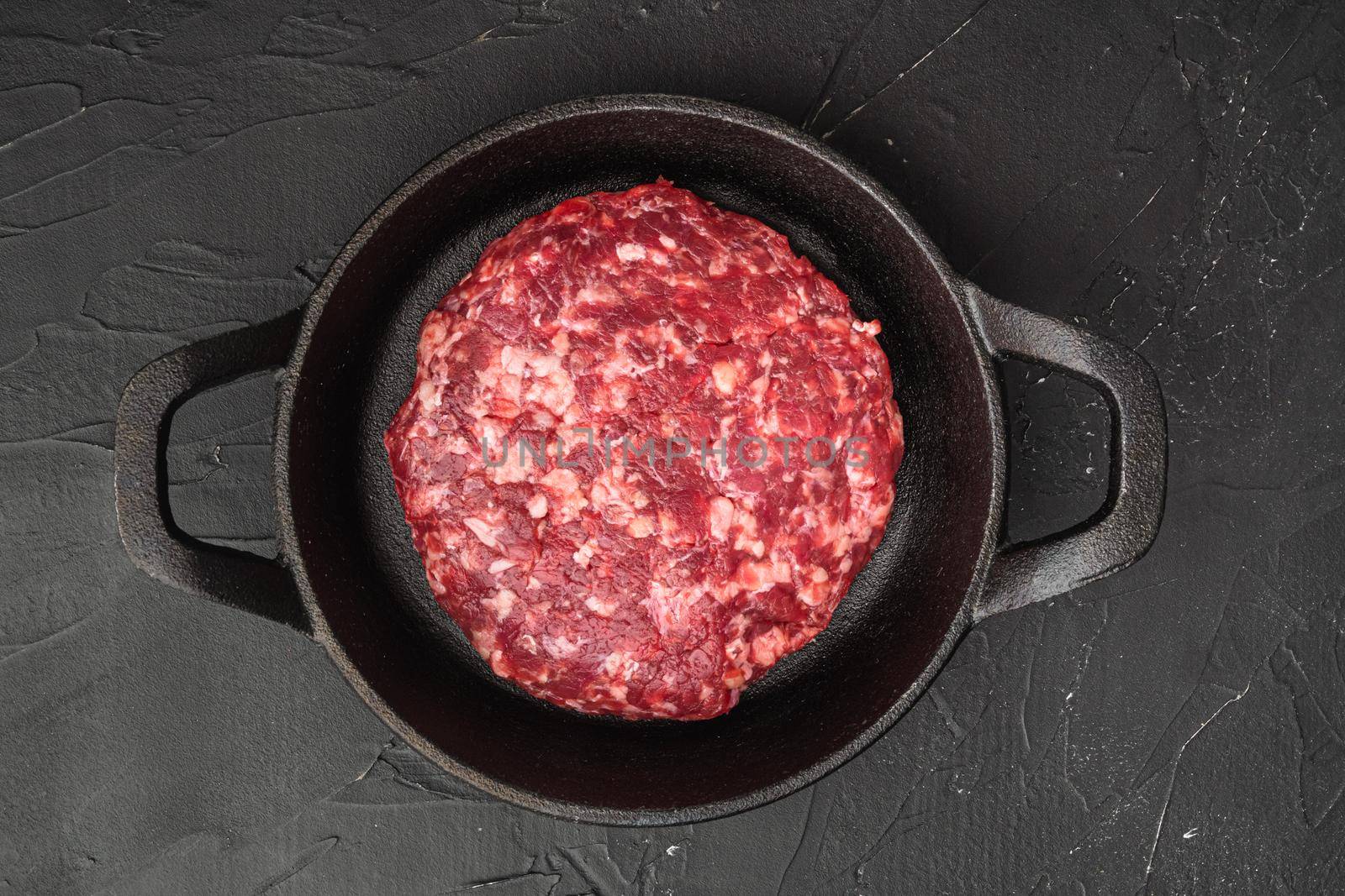 Patty of minced meat for burger set, on black stone background, top view flat lay
