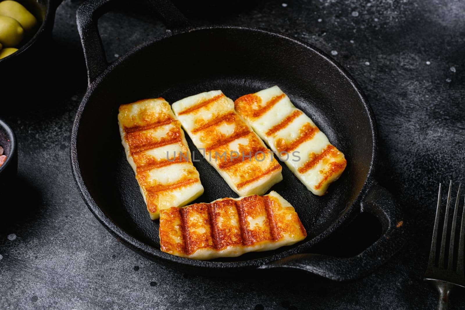 Grilled Halloumi, fried cheese set, on black dark stone table background