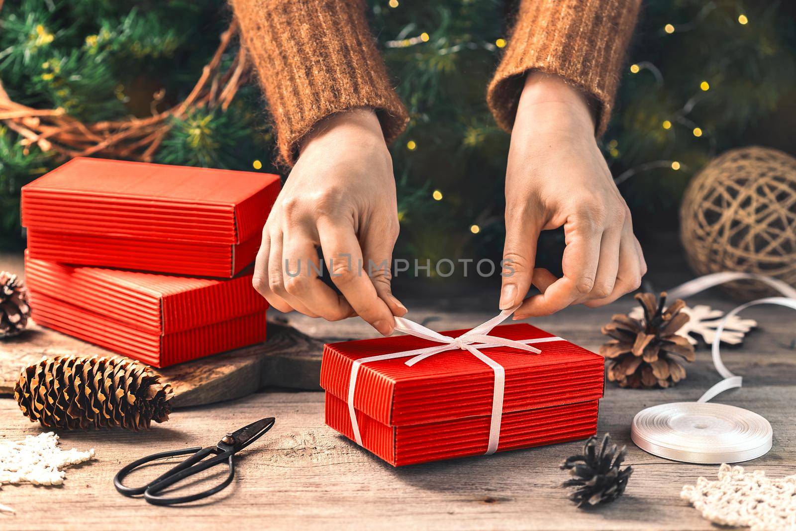 Preparing gift boxes with ribbon for xmas presents by Syvanych