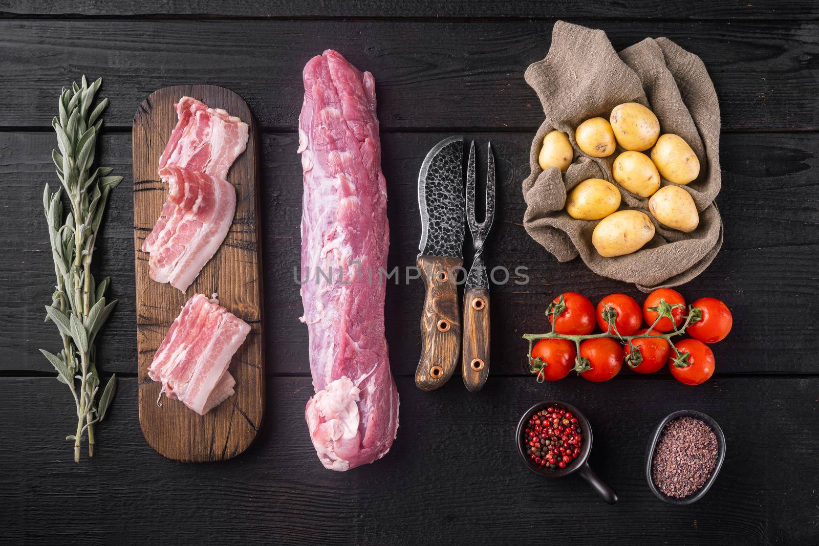 Raw pork tenderloin with ingredients and herbs , on black wooden table background, top view flat lay by Ilianesolenyi