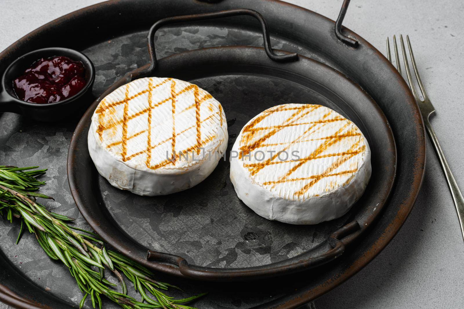 Grilled goat cheese on gray stone table background by Ilianesolenyi