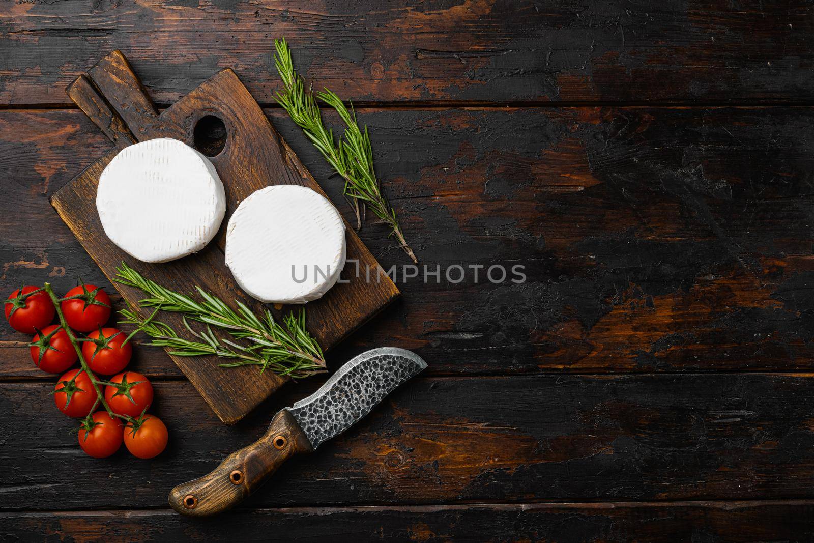 Fresh Brie cheese on old dark wooden table background, top view flat lay, with copy space for text by Ilianesolenyi