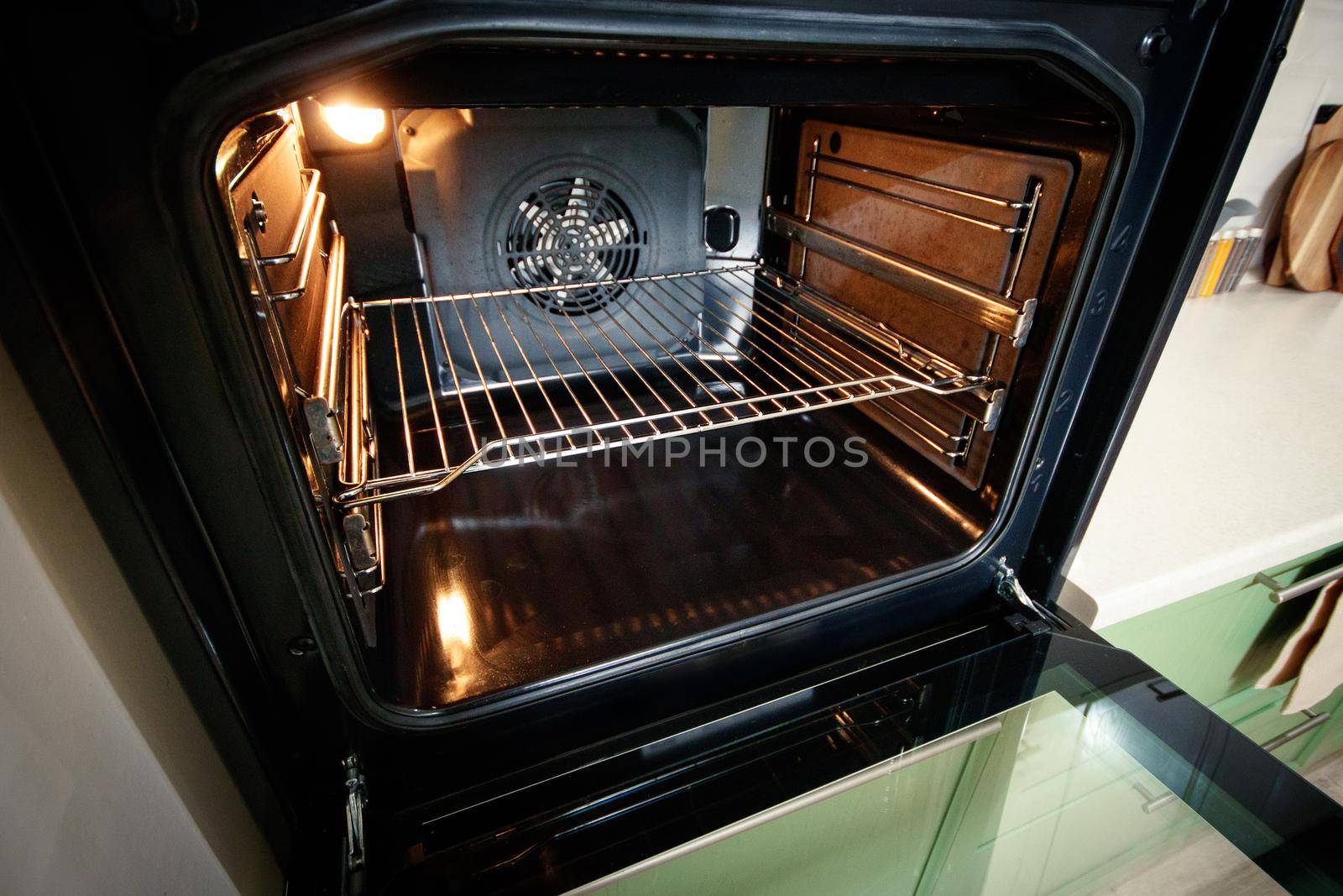 Open built-in oven with lighting in the home kitchen.